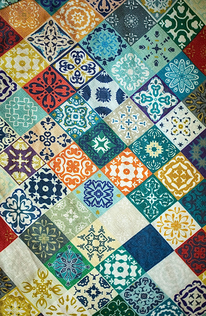 Multicolored patchwork patterned fabric with various geometric shapes and colors.
