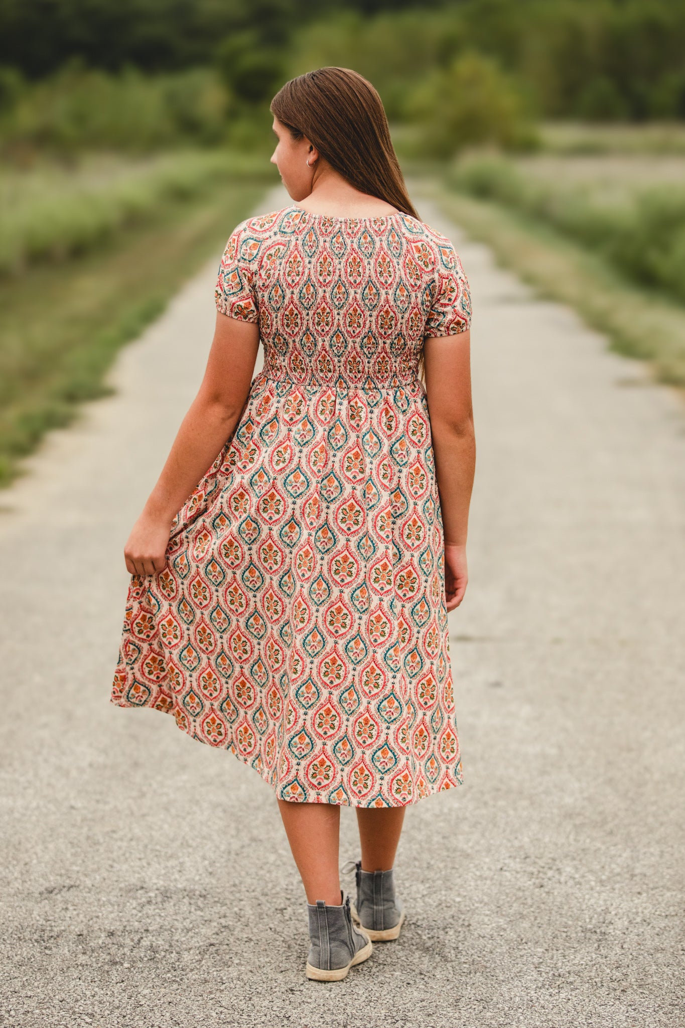 Woman wearing a patterned modest nursing dress
