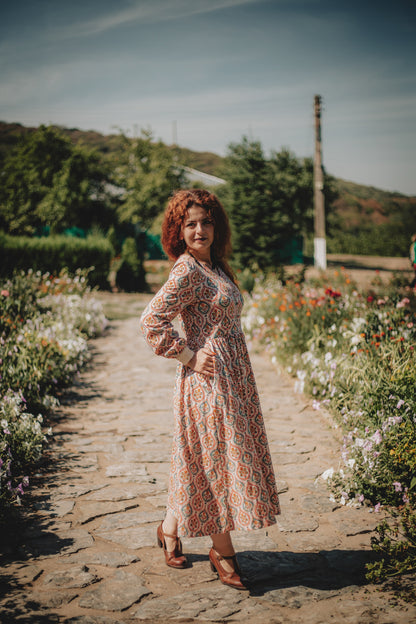 Woman wearing a patterned modest nursing dress
