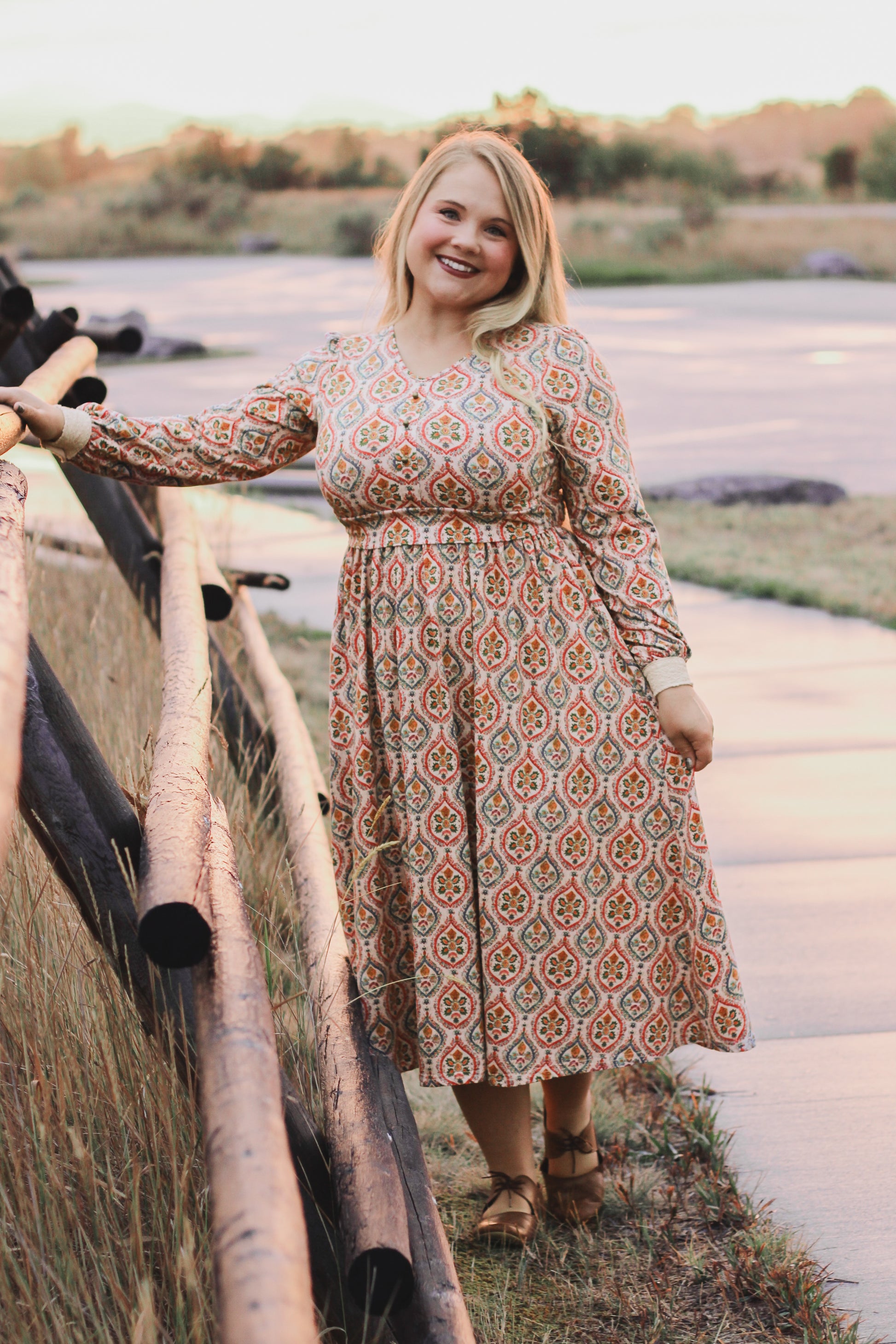 Woman wearing a patterned modest nursing dress