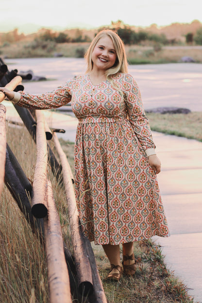 Woman wearing a patterned modest nursing dress