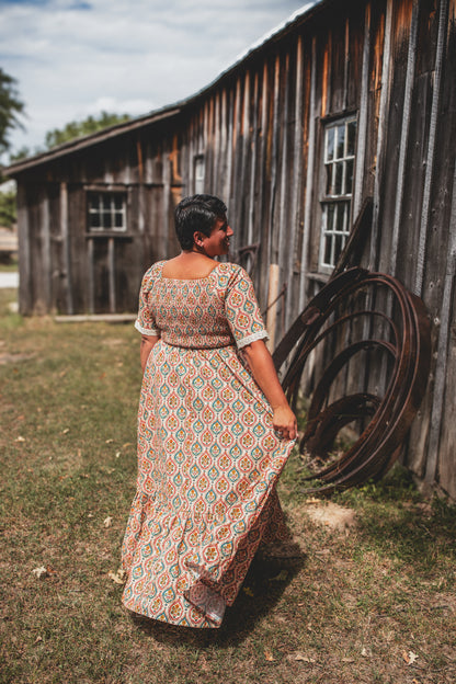 Woman wearing a patterned modest nursing dress