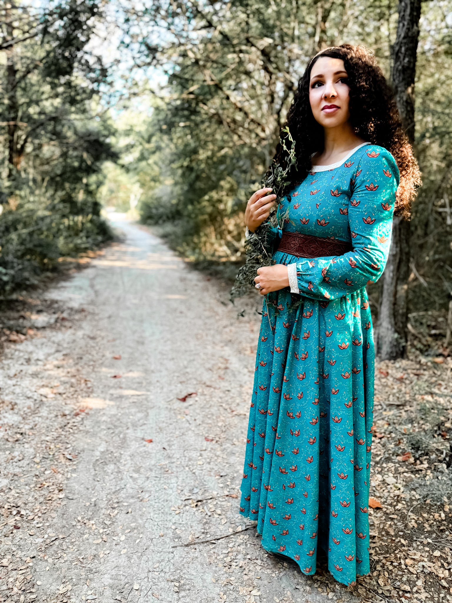 Woman in modest nursing teal dress on path