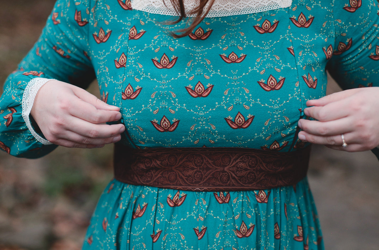 Woman in modest nursing teal floral dress outdoors