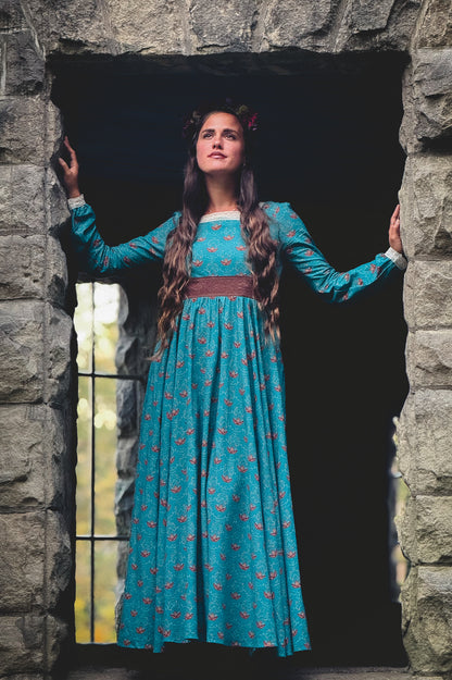 Woman in modest nursing blue dress in archway