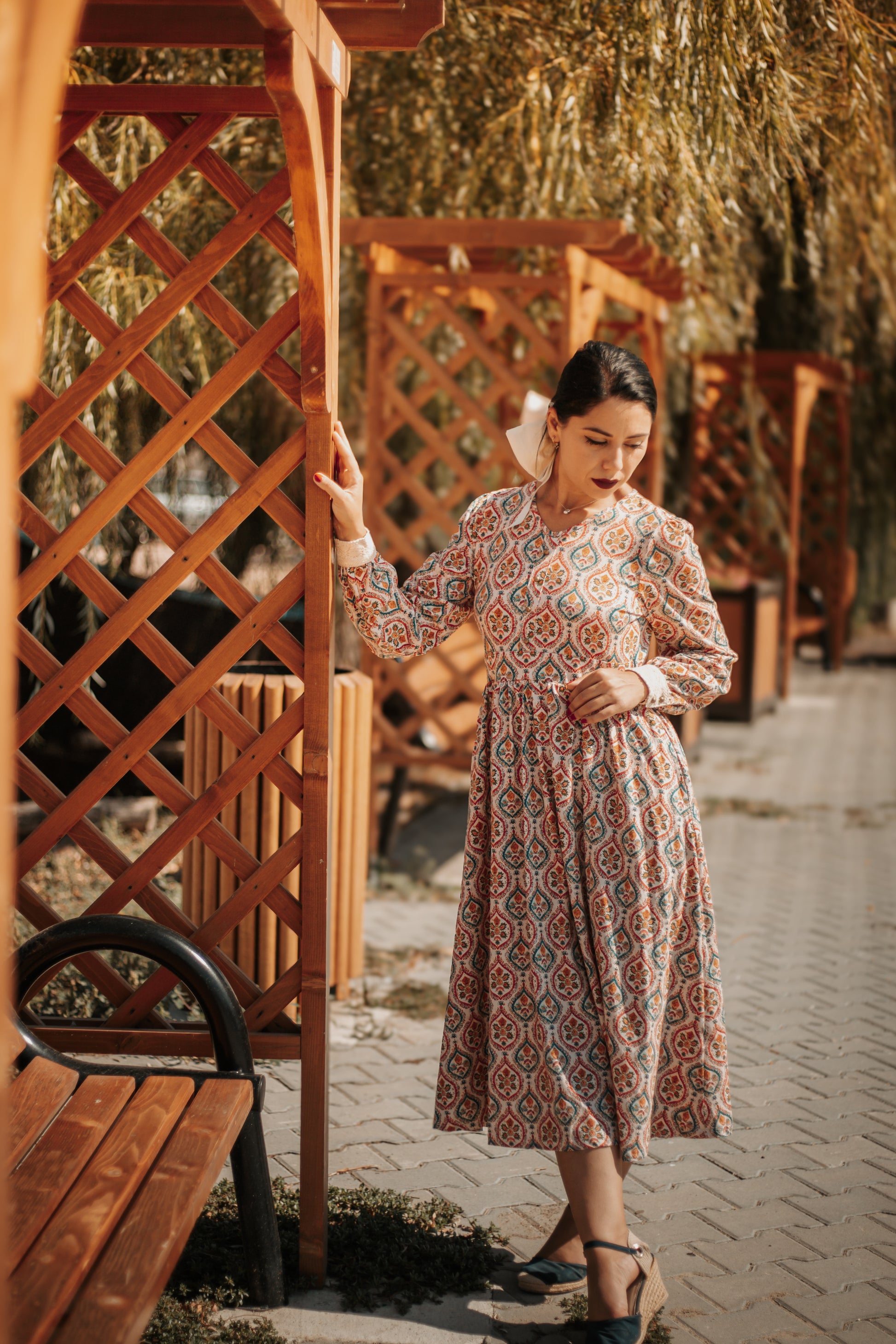Woman wearing a patterned modest nursing dress