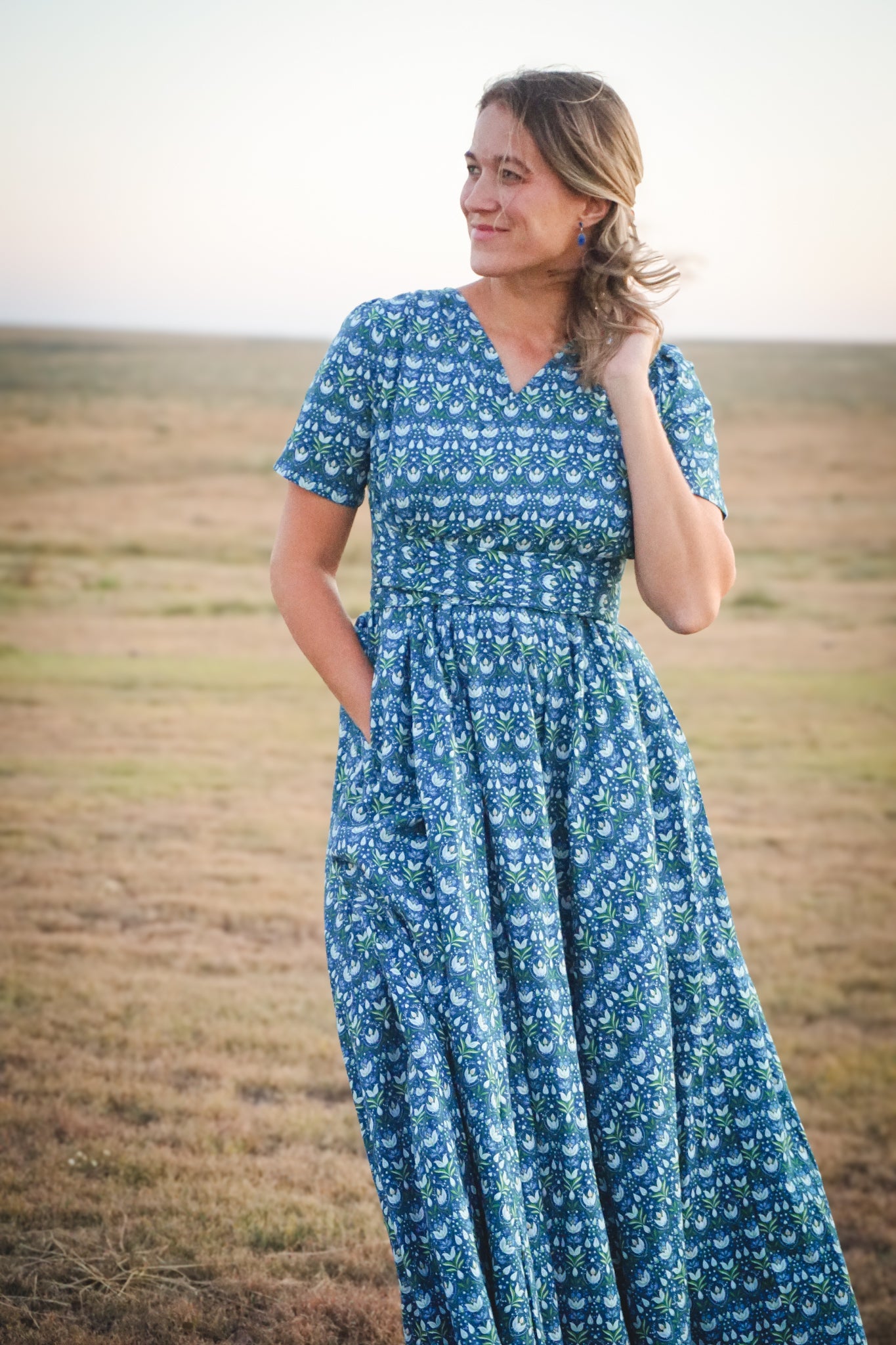 Woman in modest nursing dress in field