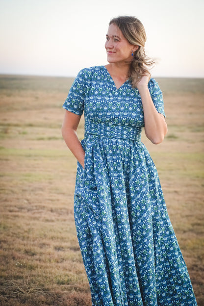 Woman in modest nursing dress in field