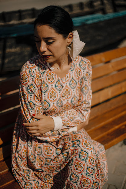 Woman wearing a patterned modest nursing dress
