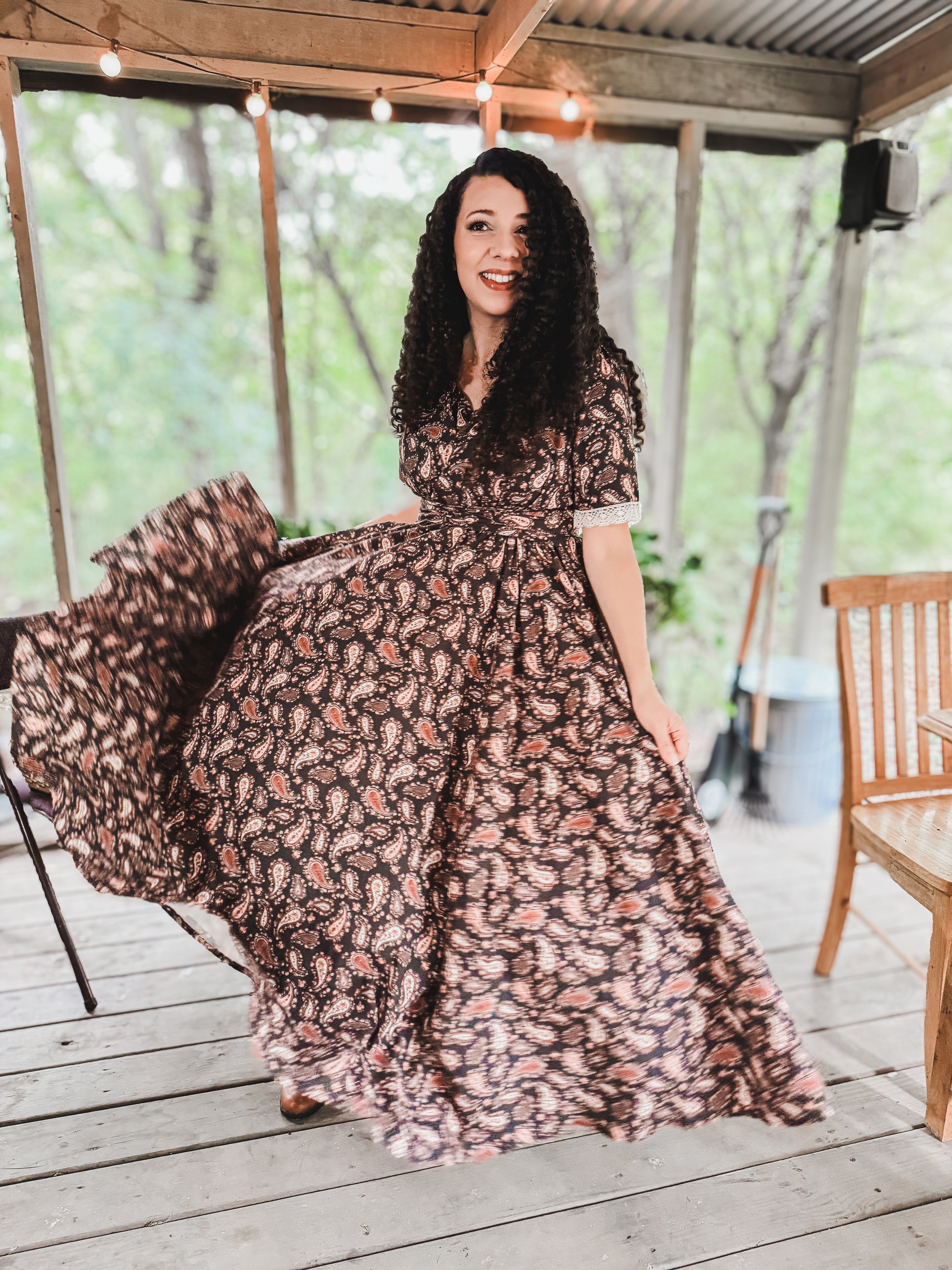 Woman in modest nursing dress on wooden deck