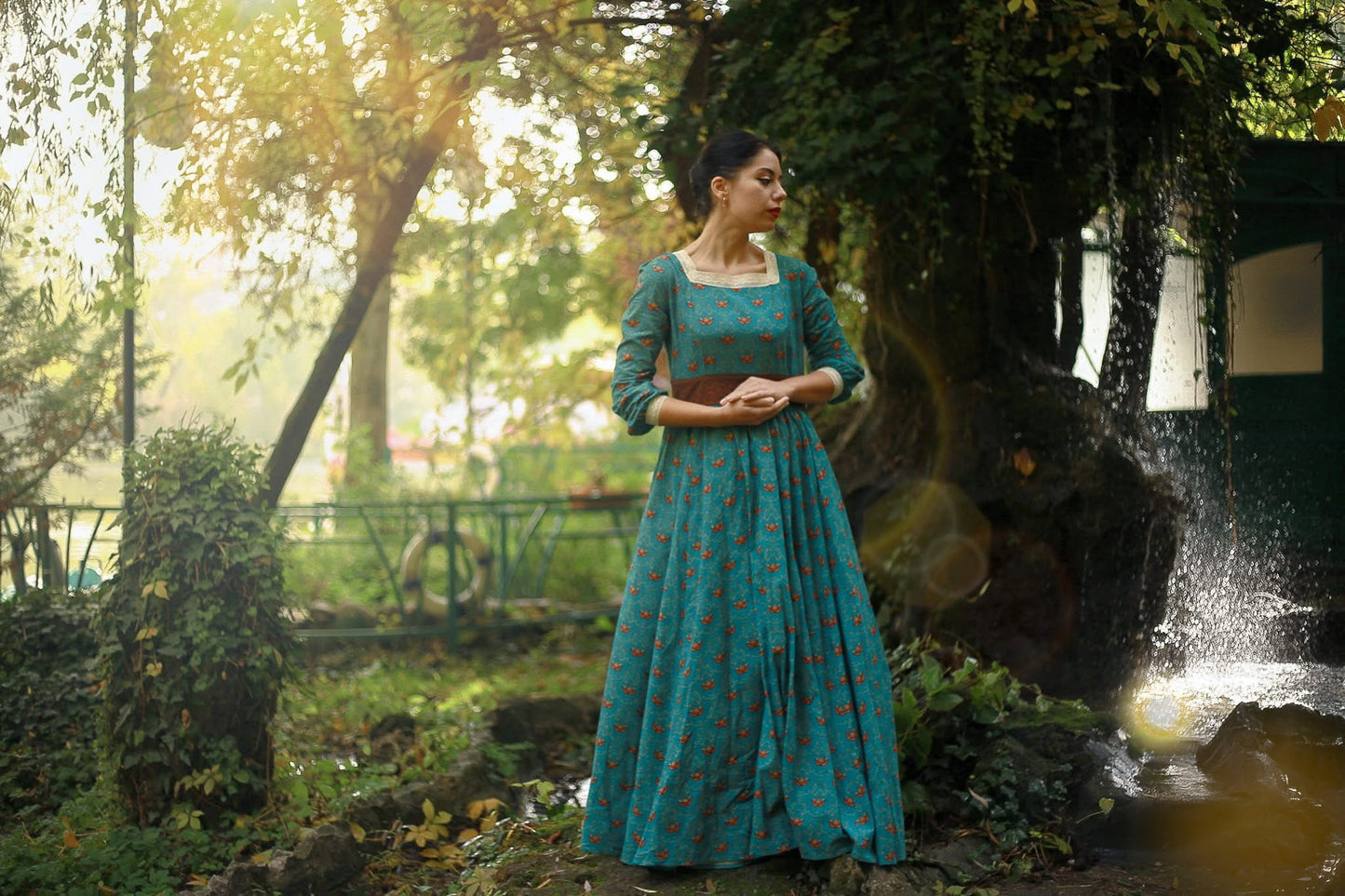 Woman in modest nursing teal dress in park