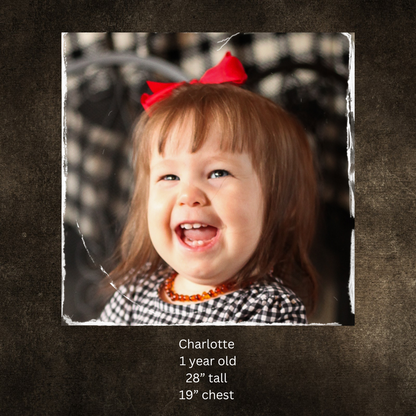 Child wearing modest dress with bow on background