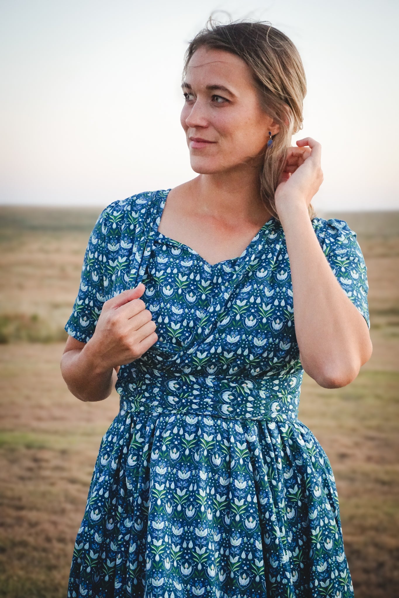 Woman in modest nursing dress in field