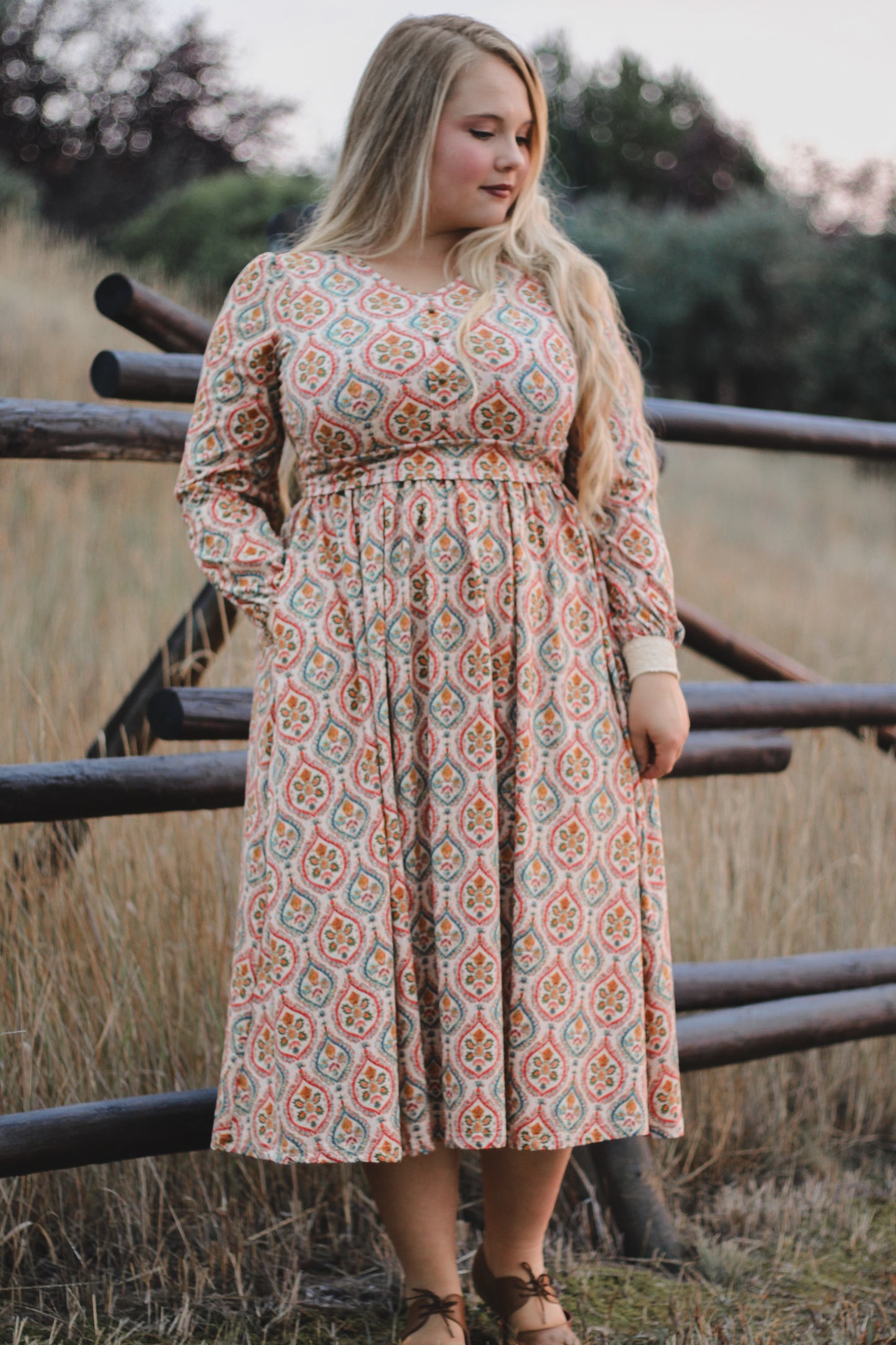 Woman wearing a patterned modest nursing dress