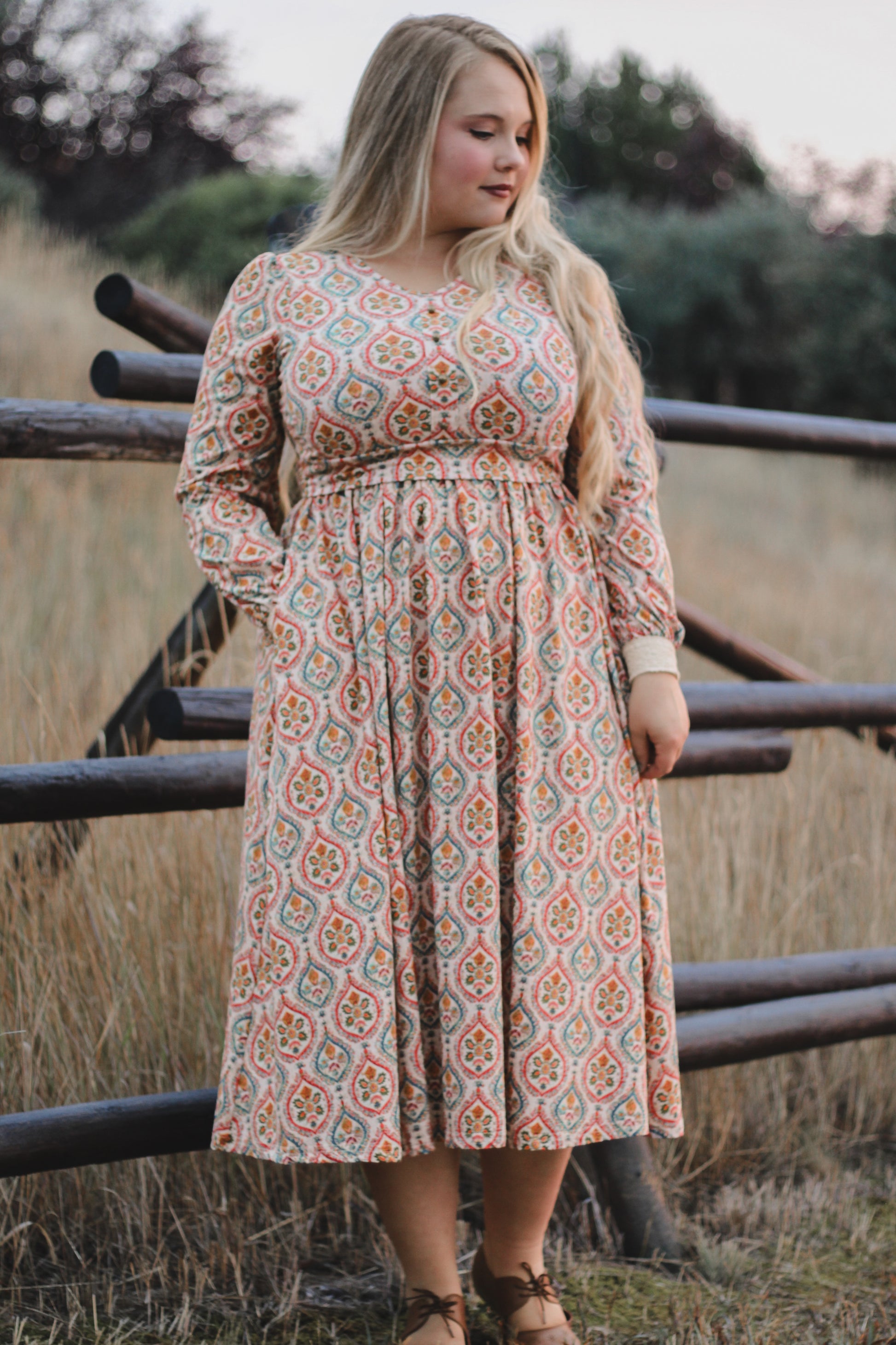 Woman wearing a patterned modest nursing dress