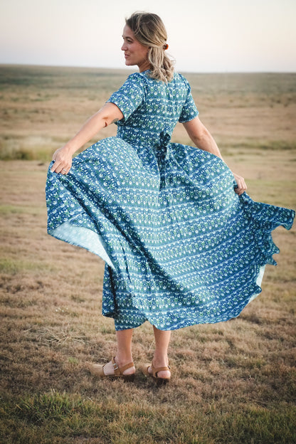 Woman in modest nursing dress in field
