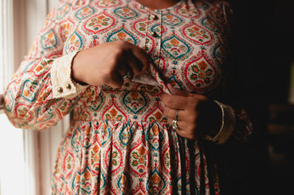 Woman wearing a patterned modest nursing dress