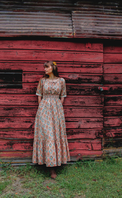 Woman wearing a patterned modest nursing dress