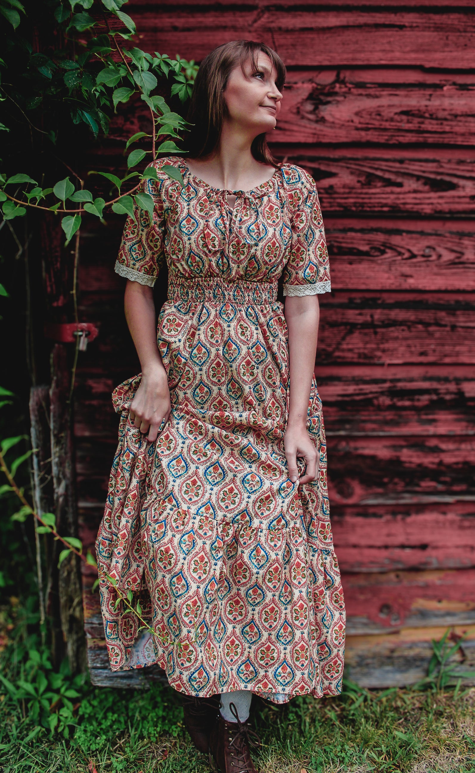 Woman wearing a patterned modest nursing dress