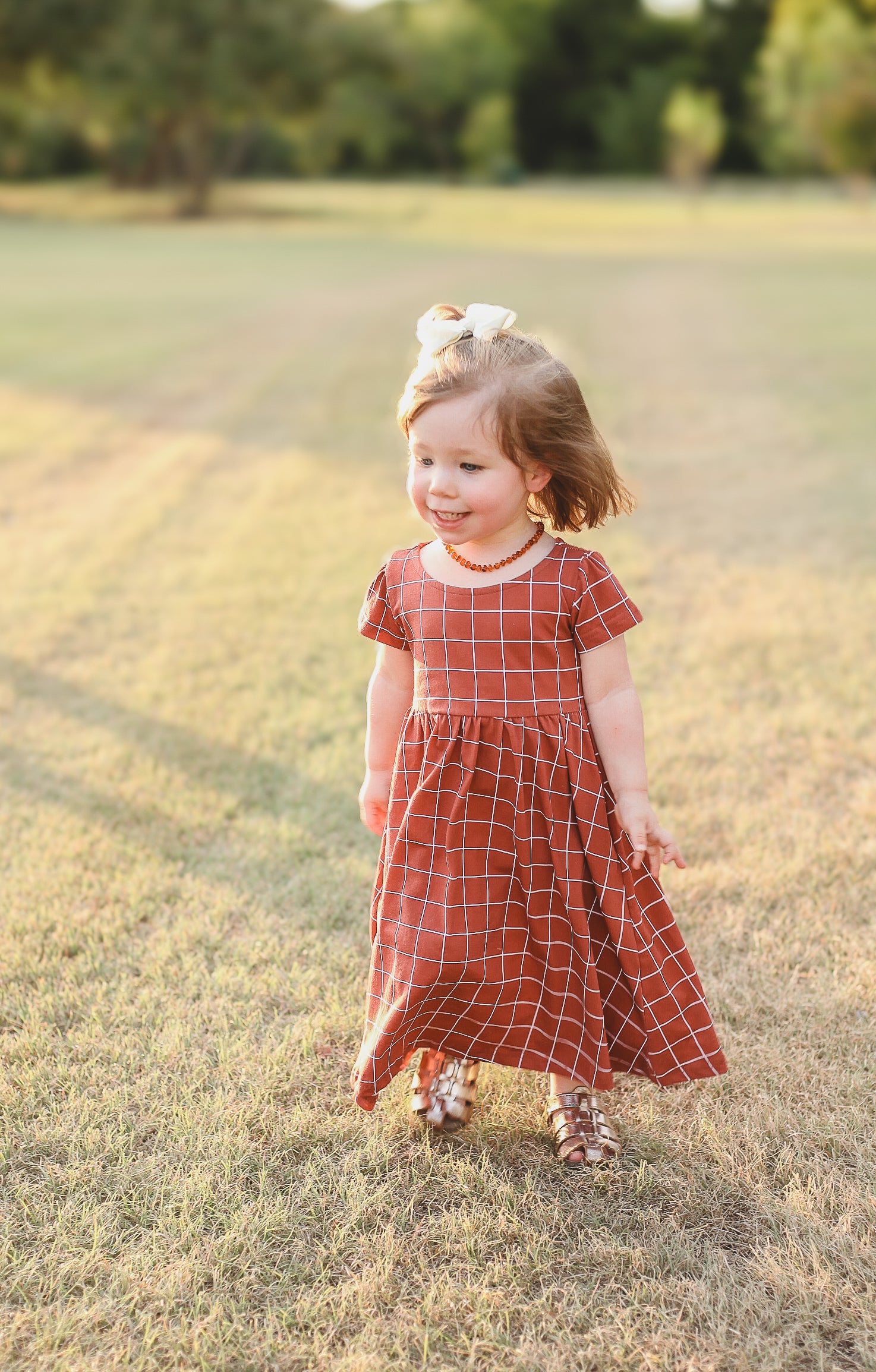 Girl in modest plaid dress, ready for nursing.