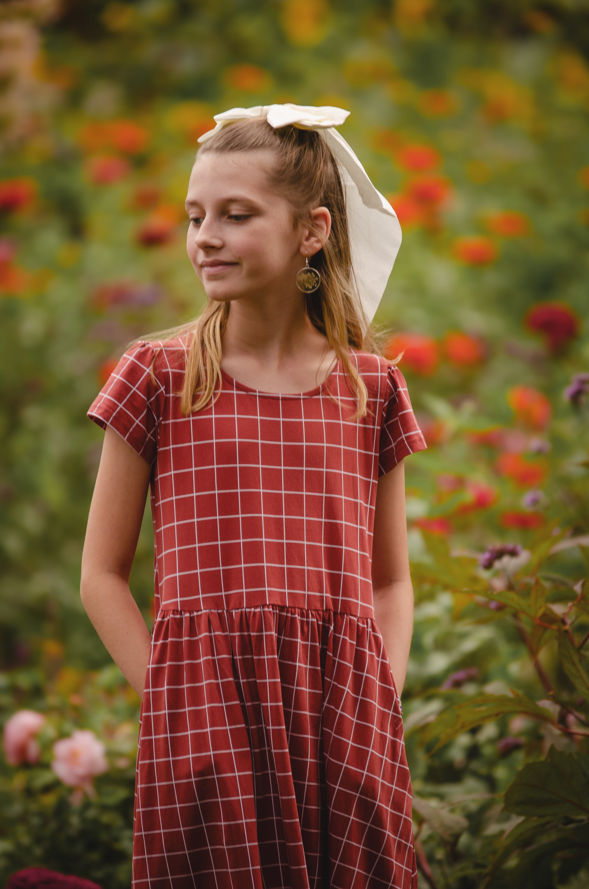 Girl in modest checkered dress, ready for nursing.