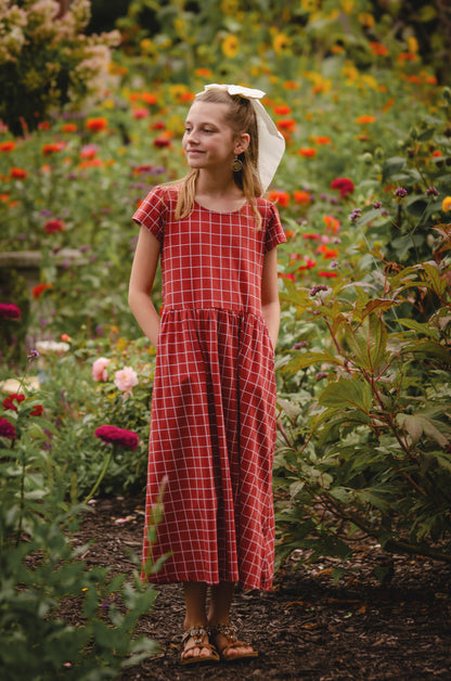 Girl in modest checkered dress, ready for nursing.