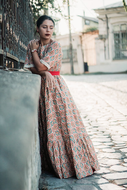 Woman wearing a patterned modest nursing dress