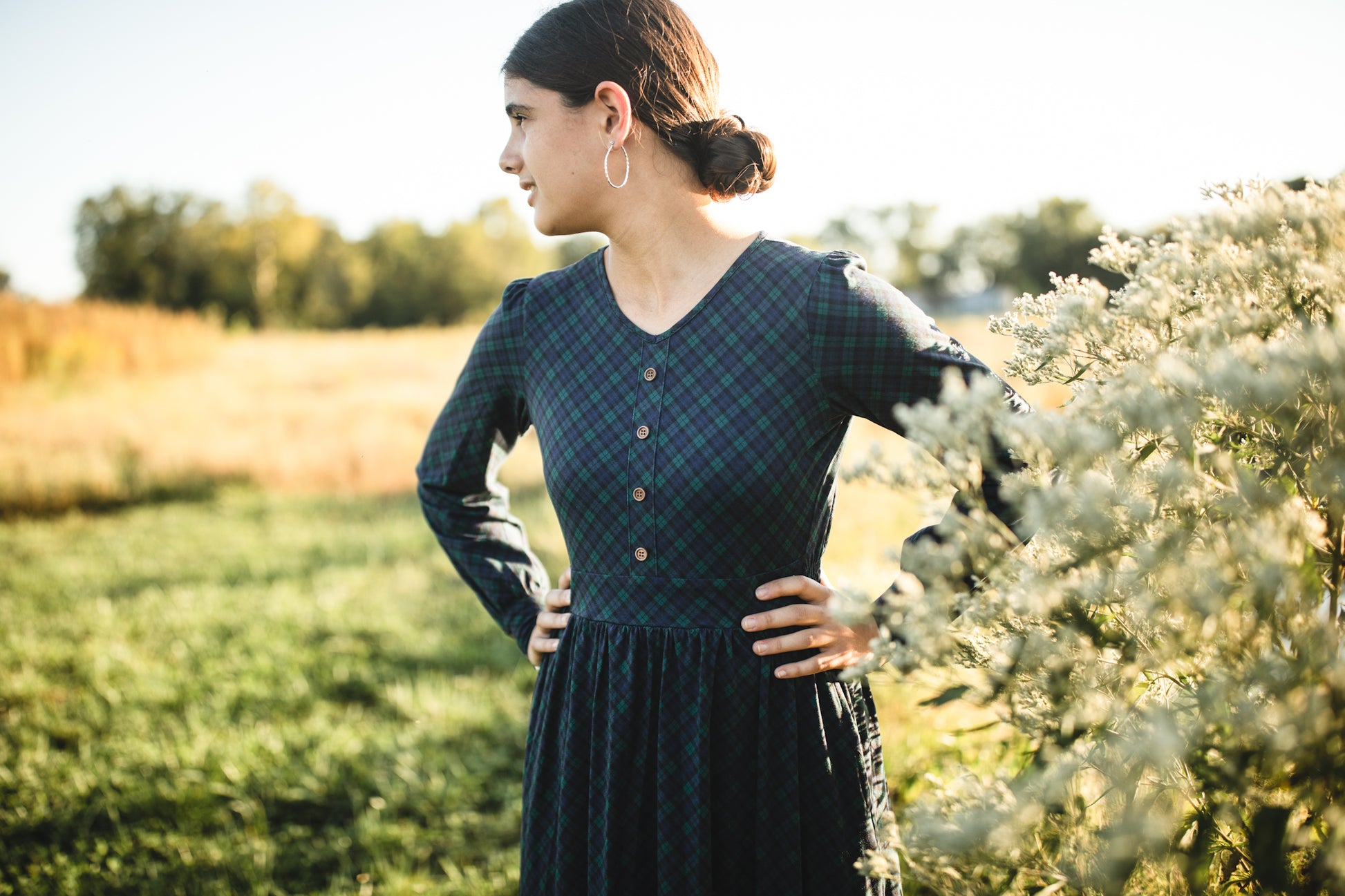 Woman in modest nursing dark green dress outdoors