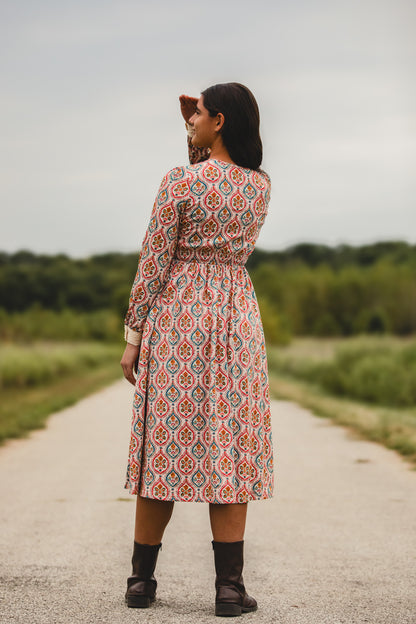 Woman wearing a patterned modest nursing dress