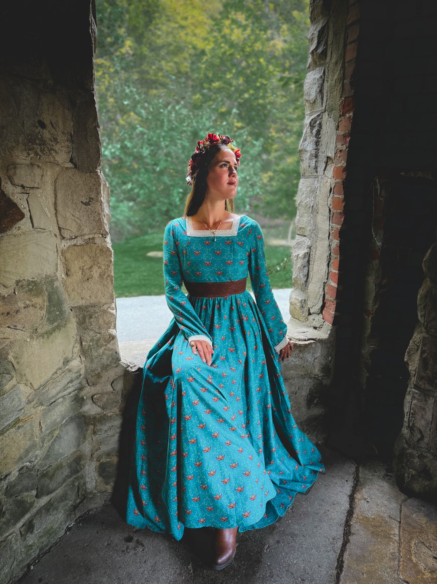 Woman in modest nursing blue dress in archway