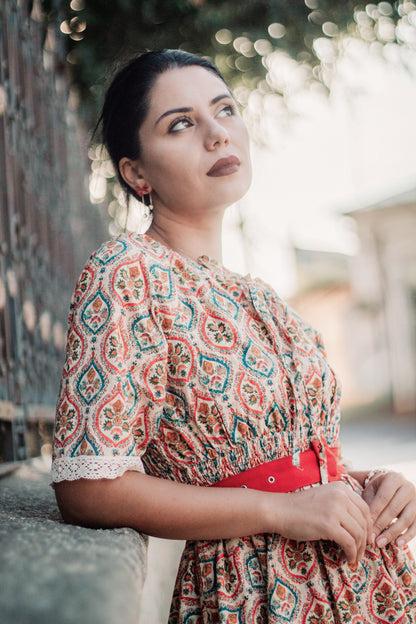 Woman wearing a patterned modest nursing dress