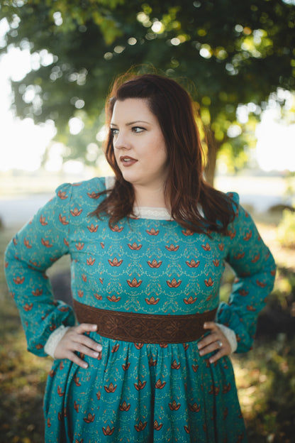 Woman in modest nursing teal patterned dress outdoors
