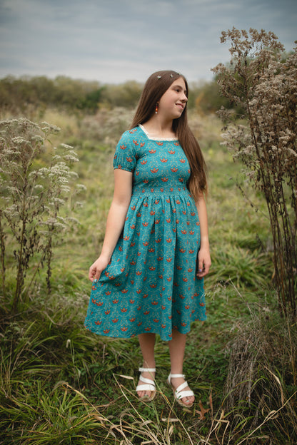 Woman wearing modest nursing dress with floral pattern.