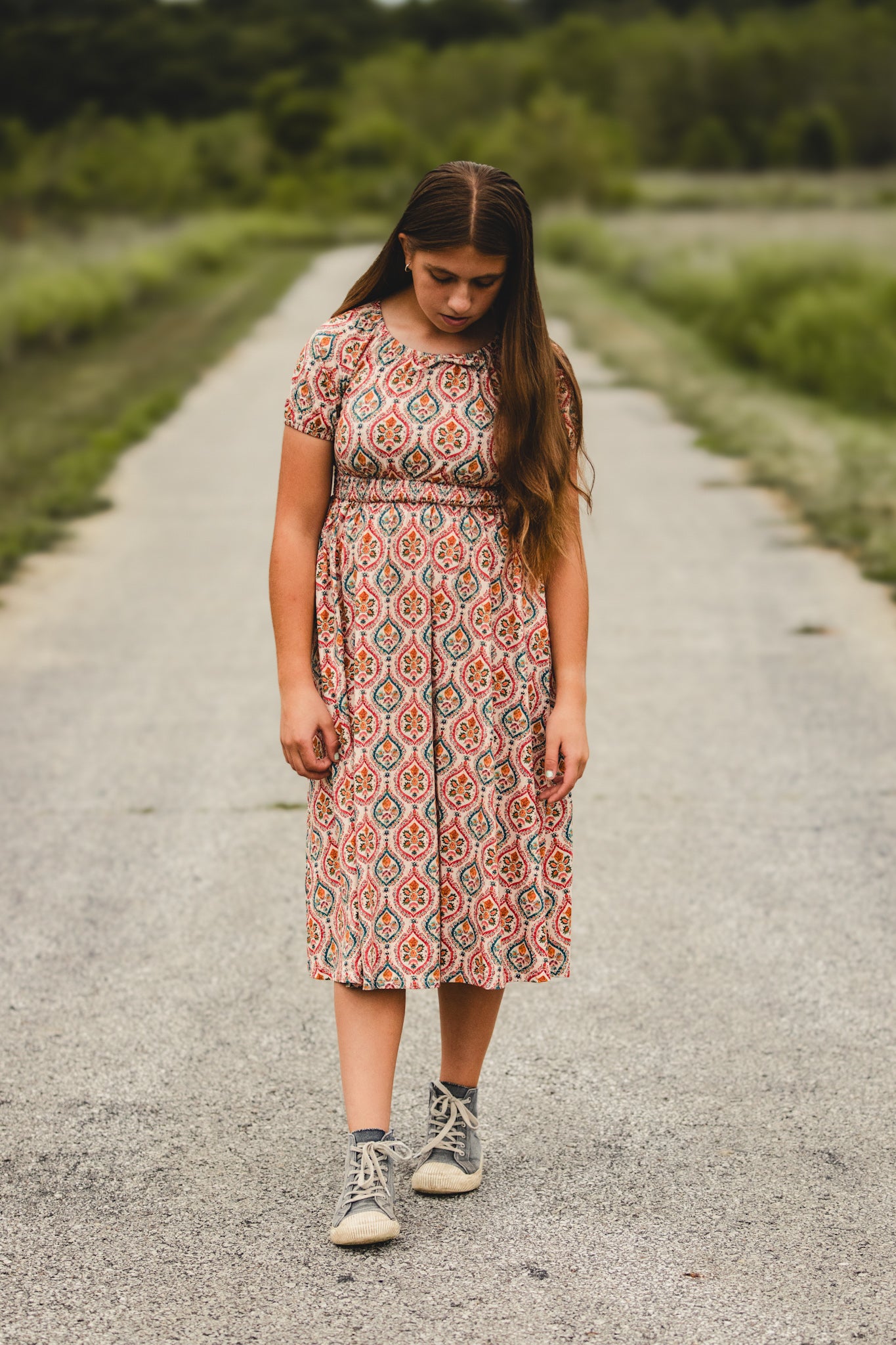 Woman in modest nursing dress on gravel road