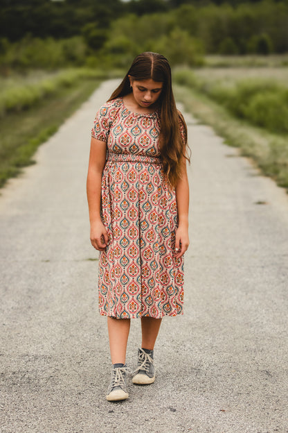 Woman in modest nursing dress on gravel road