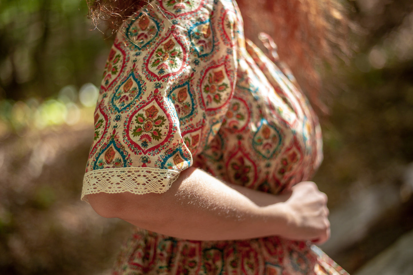 Woman wearing a patterned modest nursing dress