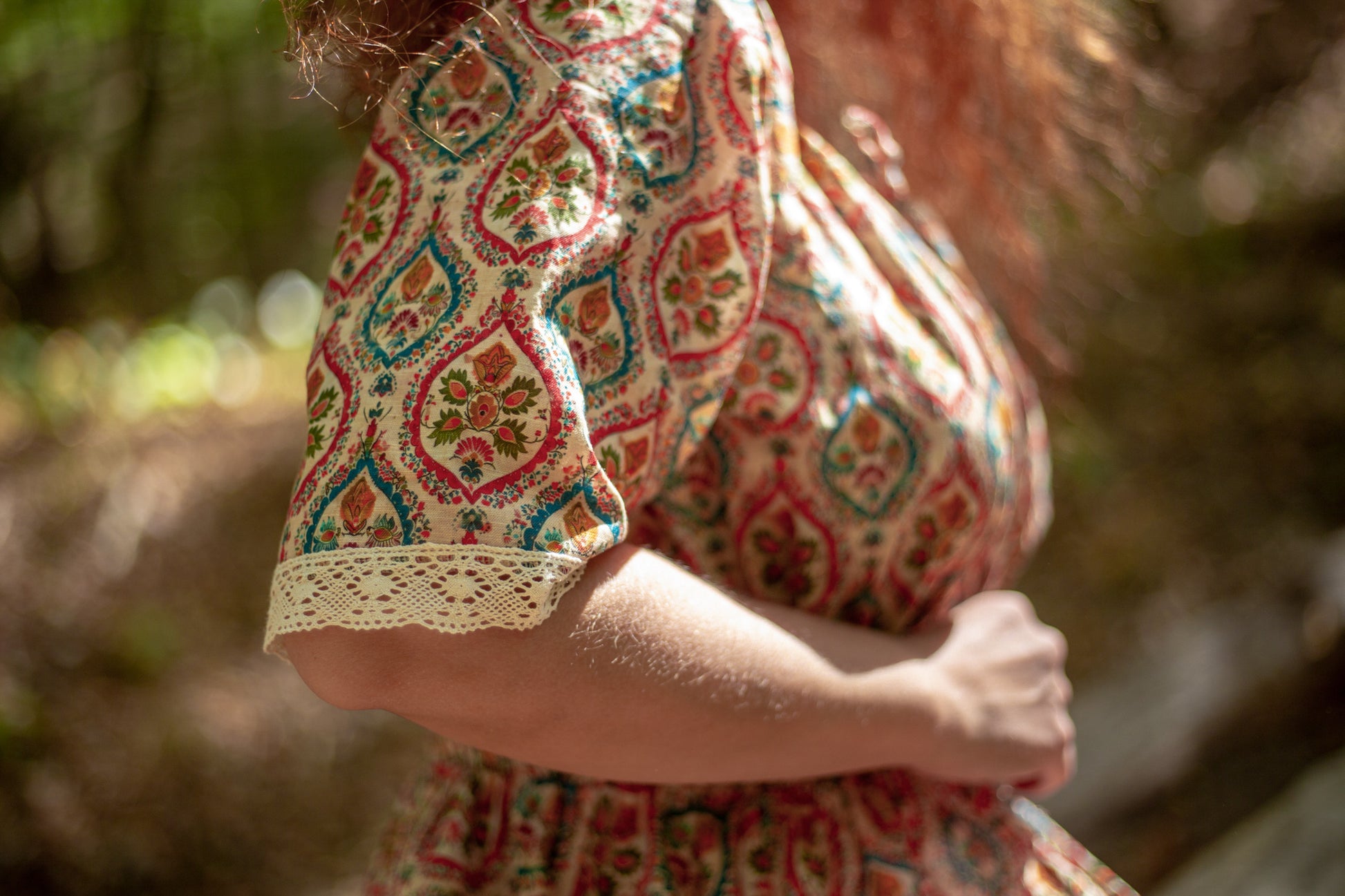 Woman wearing a patterned modest nursing dress