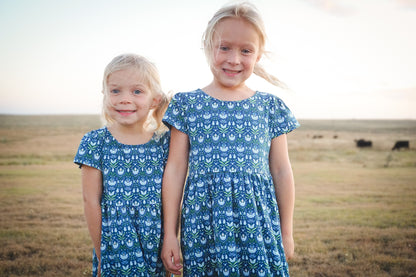 Two girls in modest floral dresses at sunset