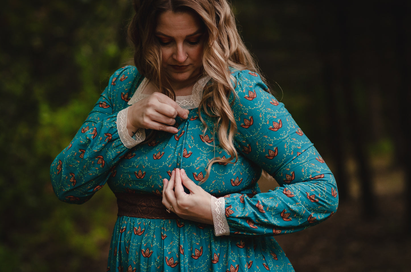 Woman in modest nursing blue dress in forest