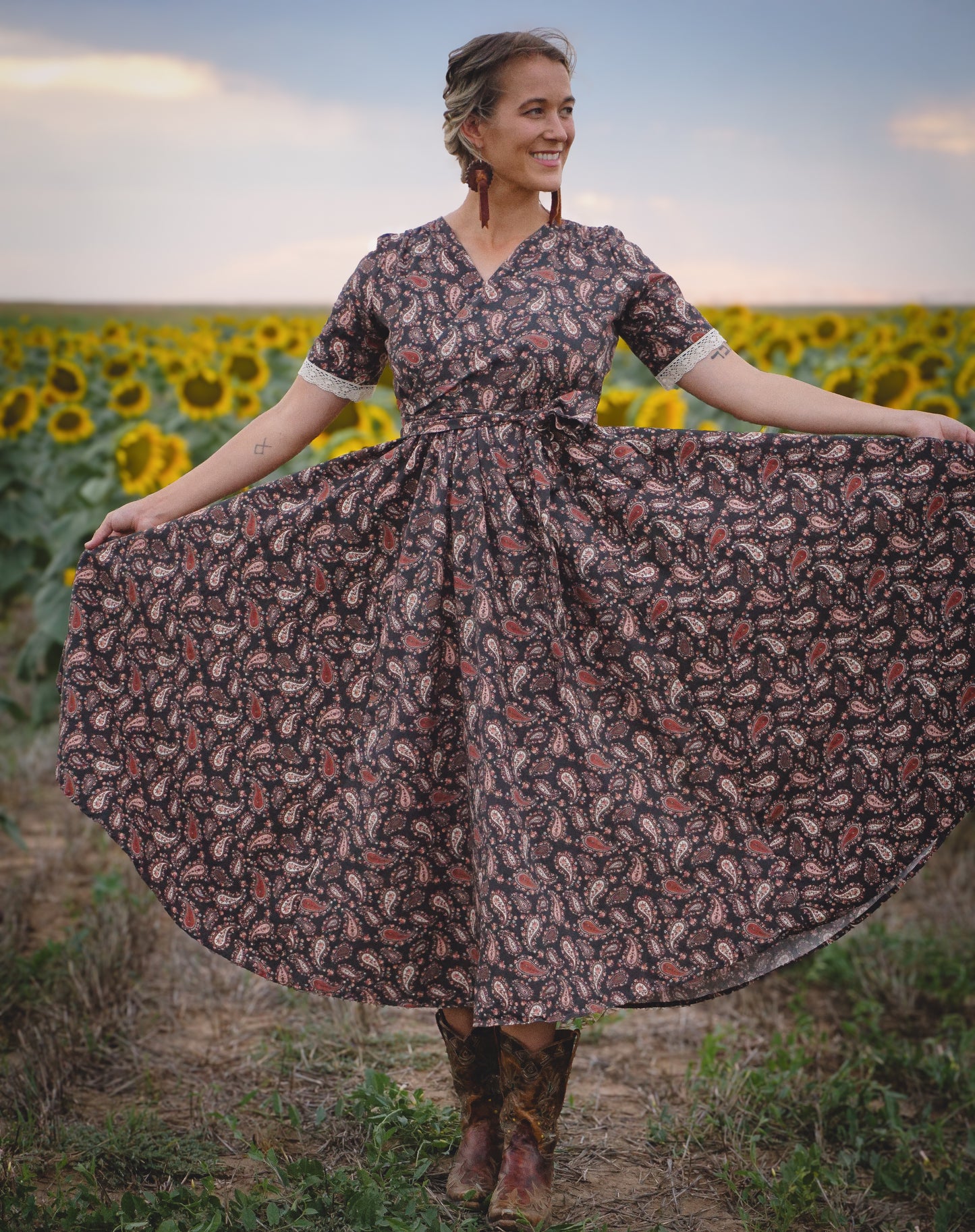 Woman in modest nursing dress in sunflower field
