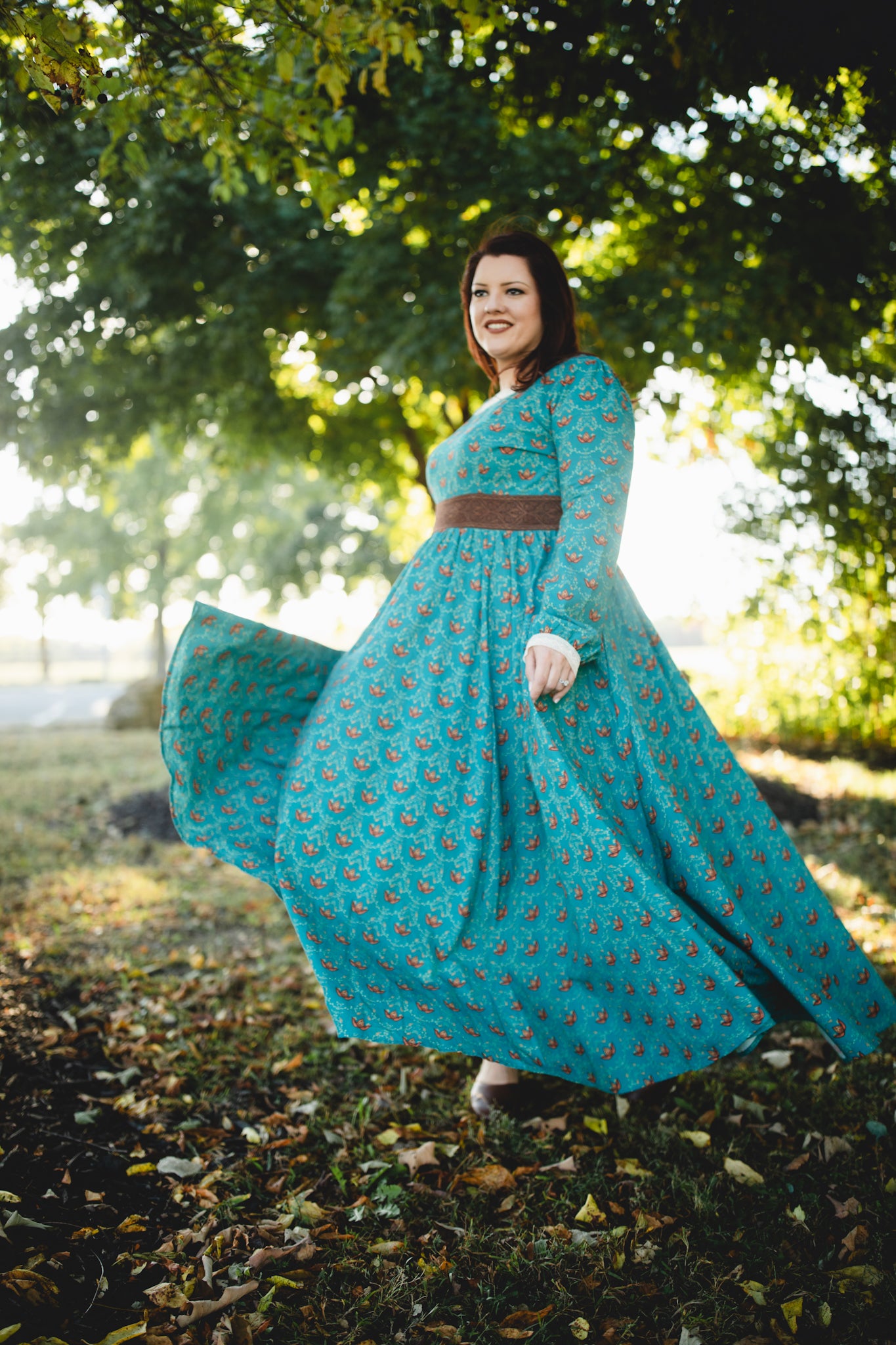 Woman in modest nursing teal dress with belt