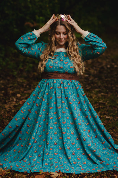 Woman in modest nursing teal dress in forest