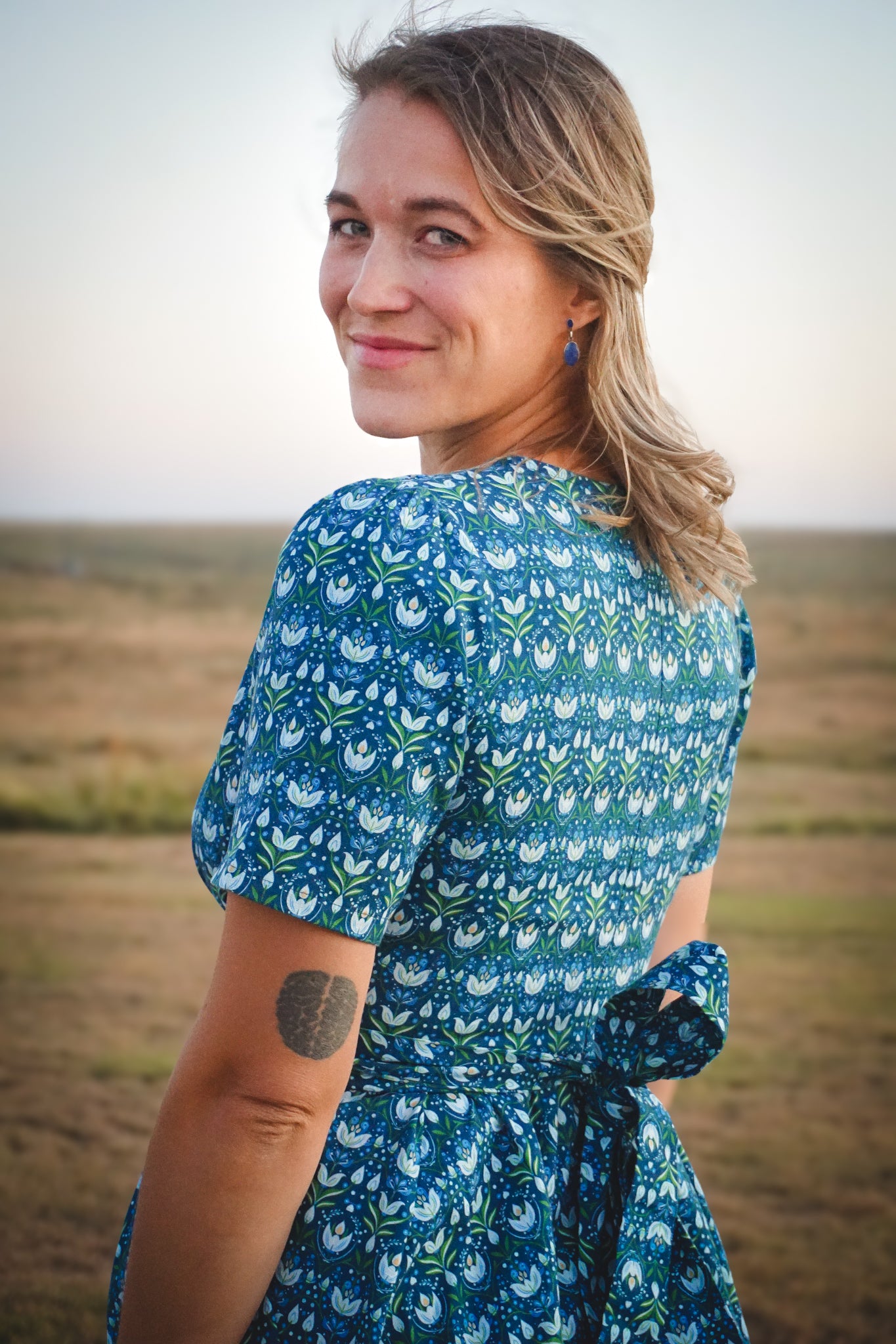 Woman in modest nursing dress in field