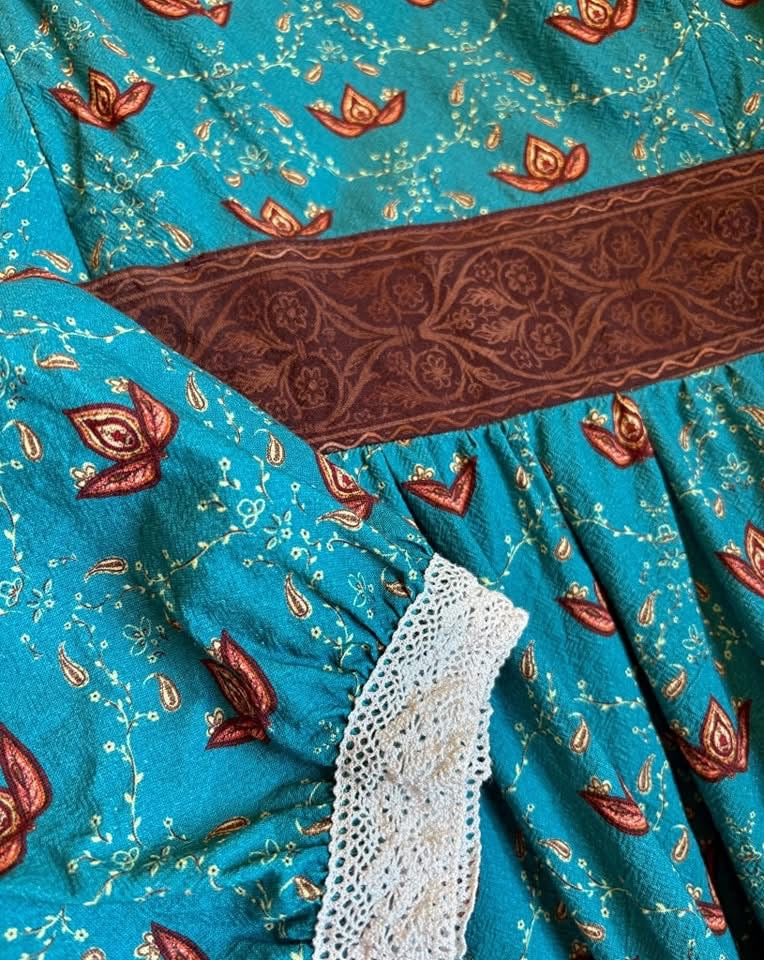 Close-up of teal fabric with floral pattern