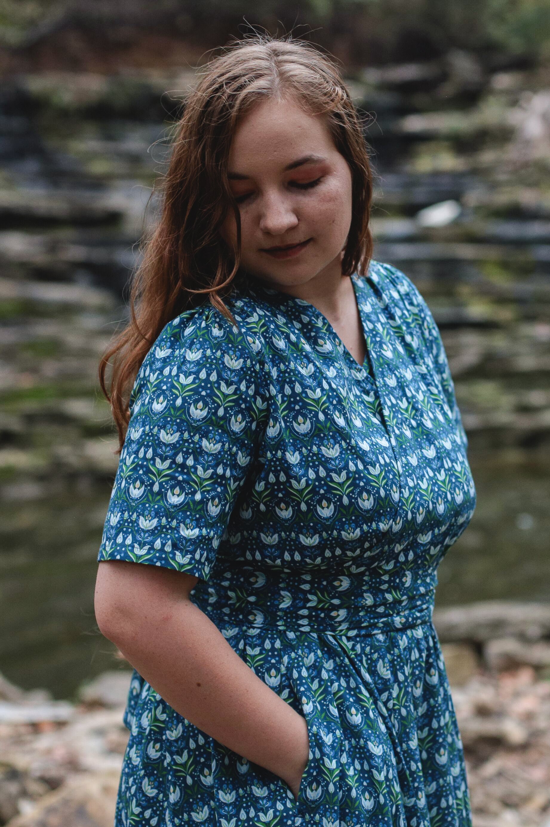 Woman in modest nursing dress near water