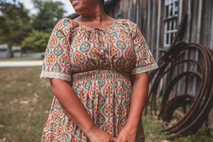 Woman wearing a patterned modest nursing dress