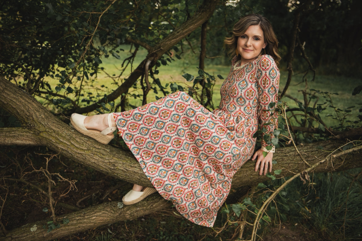 Woman wearing a patterned modest nursing dress