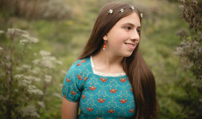 Young girl wearing modest dress outdoors naturally