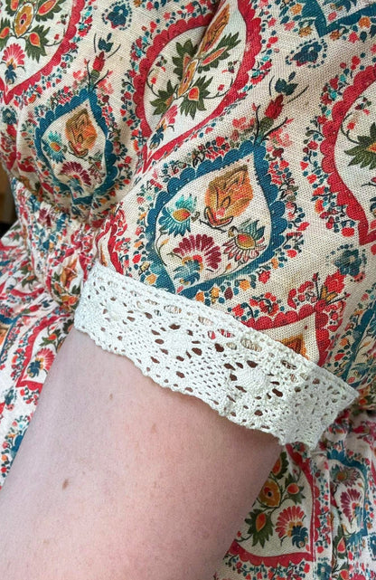Woman wearing a patterned modest nursing dress